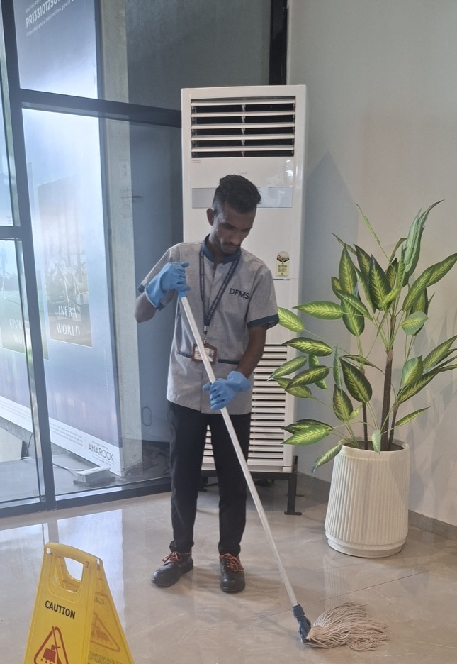 DFMS worker mopping with safety protocols in place