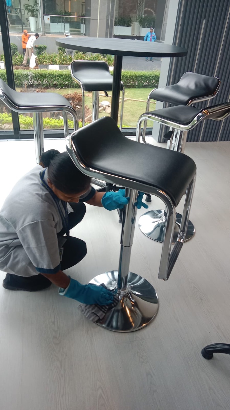 DFMS staff cleaning furniture in a modern office